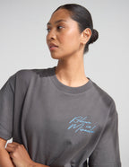 Dark Coastal Graphic Tee — "Follow the Moonlight" Surfer Silhouette T-Shirt